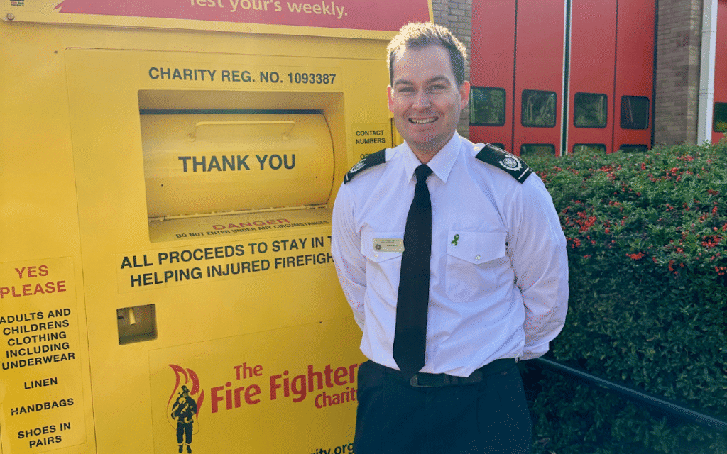 Bucks Fire officer standing next to Firefighter charity recycling bin