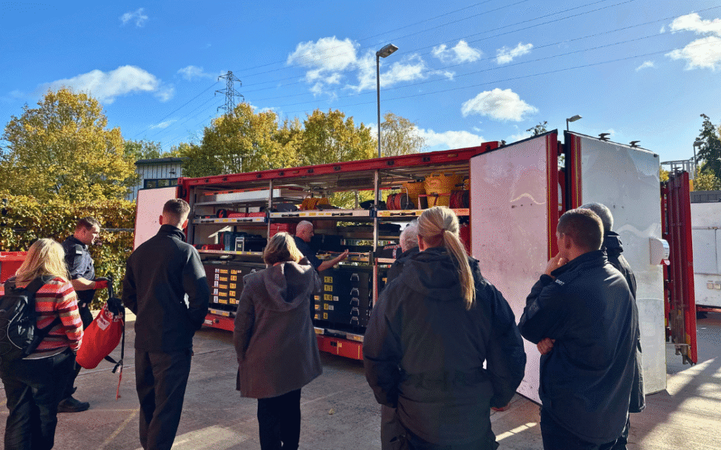 Group of people looking around USAR truck equipment